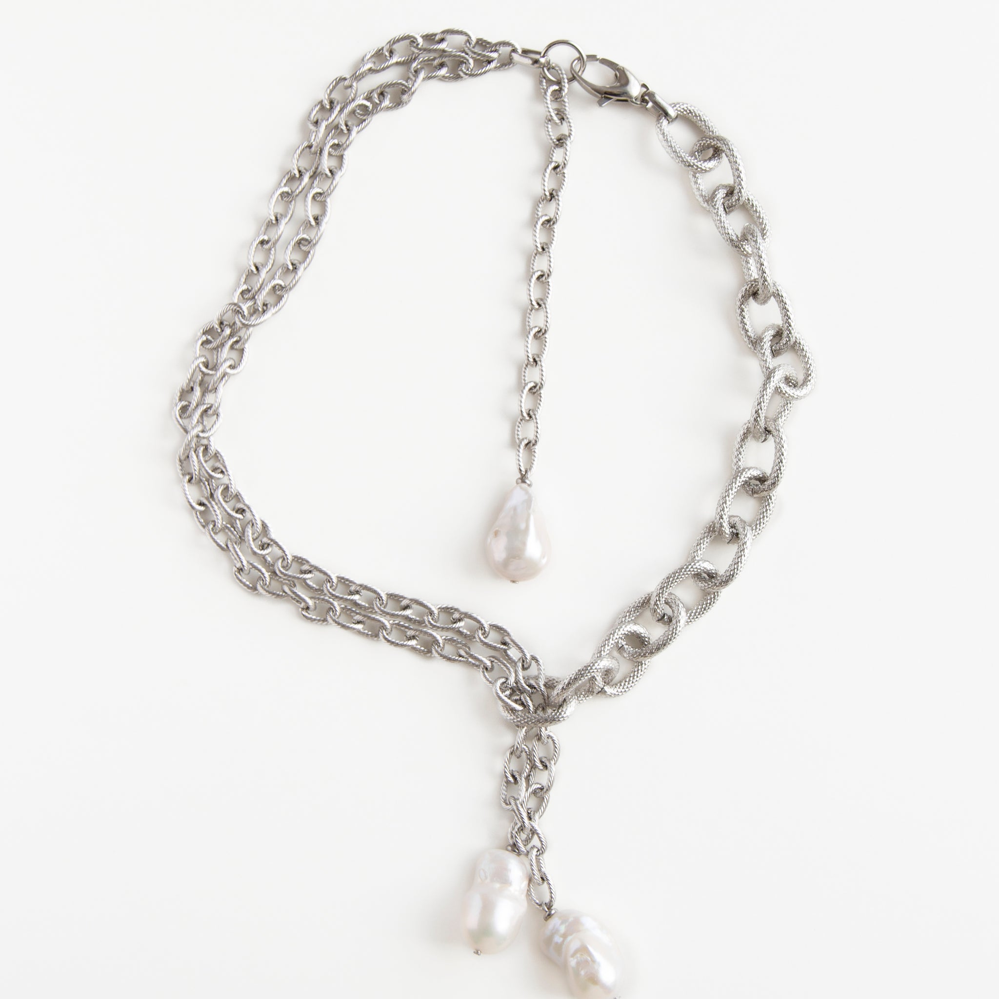 Silver Rain necklace from Jewell Reef displayed on a white background, featuring layered jewelry steel chains and baroque pearls.