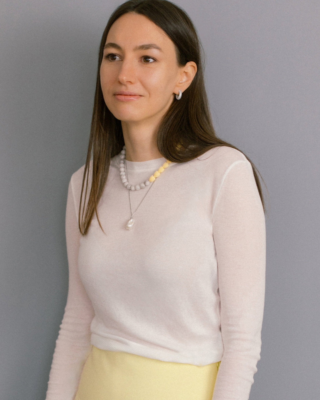 Minimalist necklace with a single baroque freshwater pearl pendant on fine stainless steel chain, elegant and timeless design.