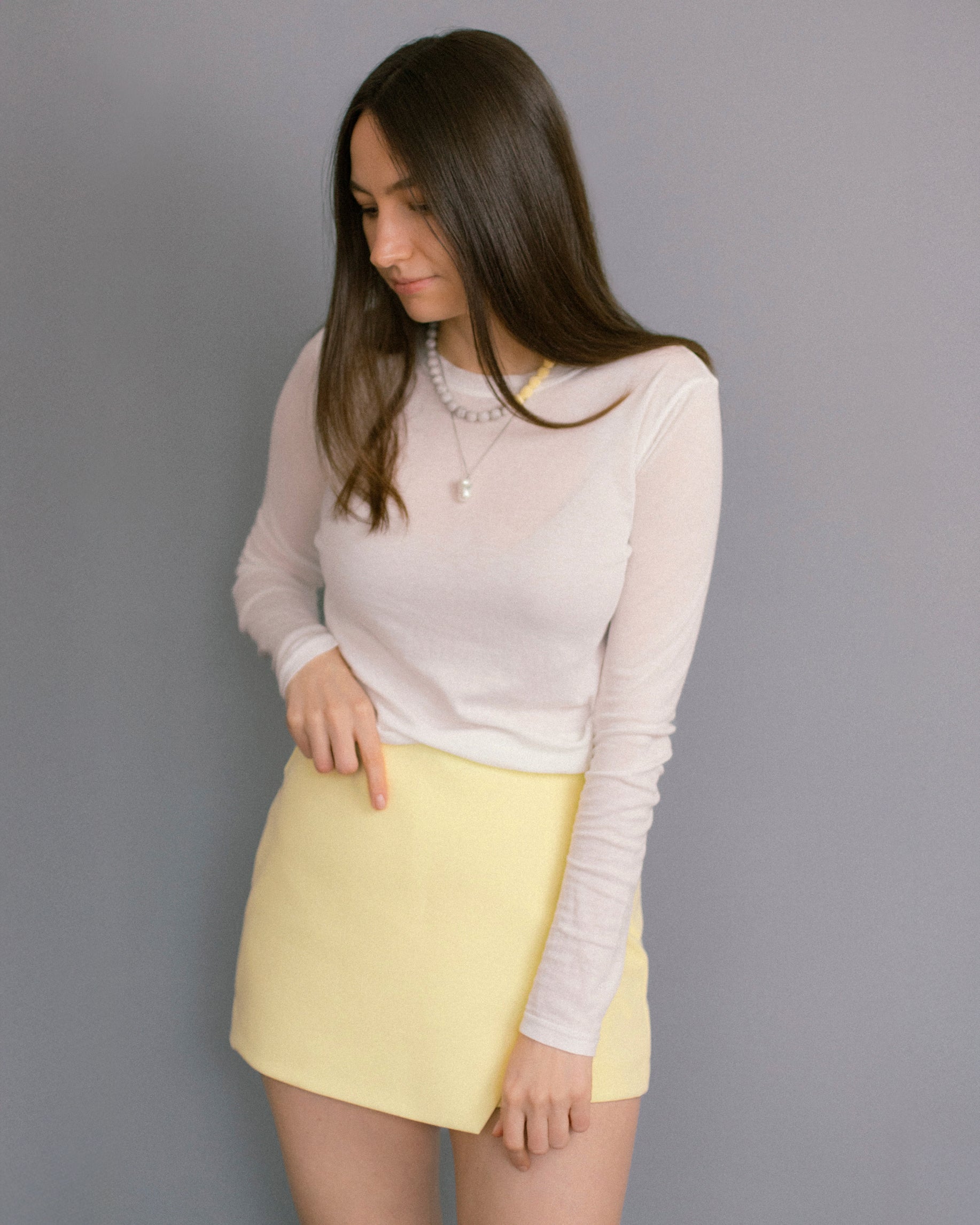 Layered look with Bare Pearl Necklace and Soft Bloom beaded chain. Minimalist pearl pendant styled with pastel jewelry for a fresh, modern everyday outfit.