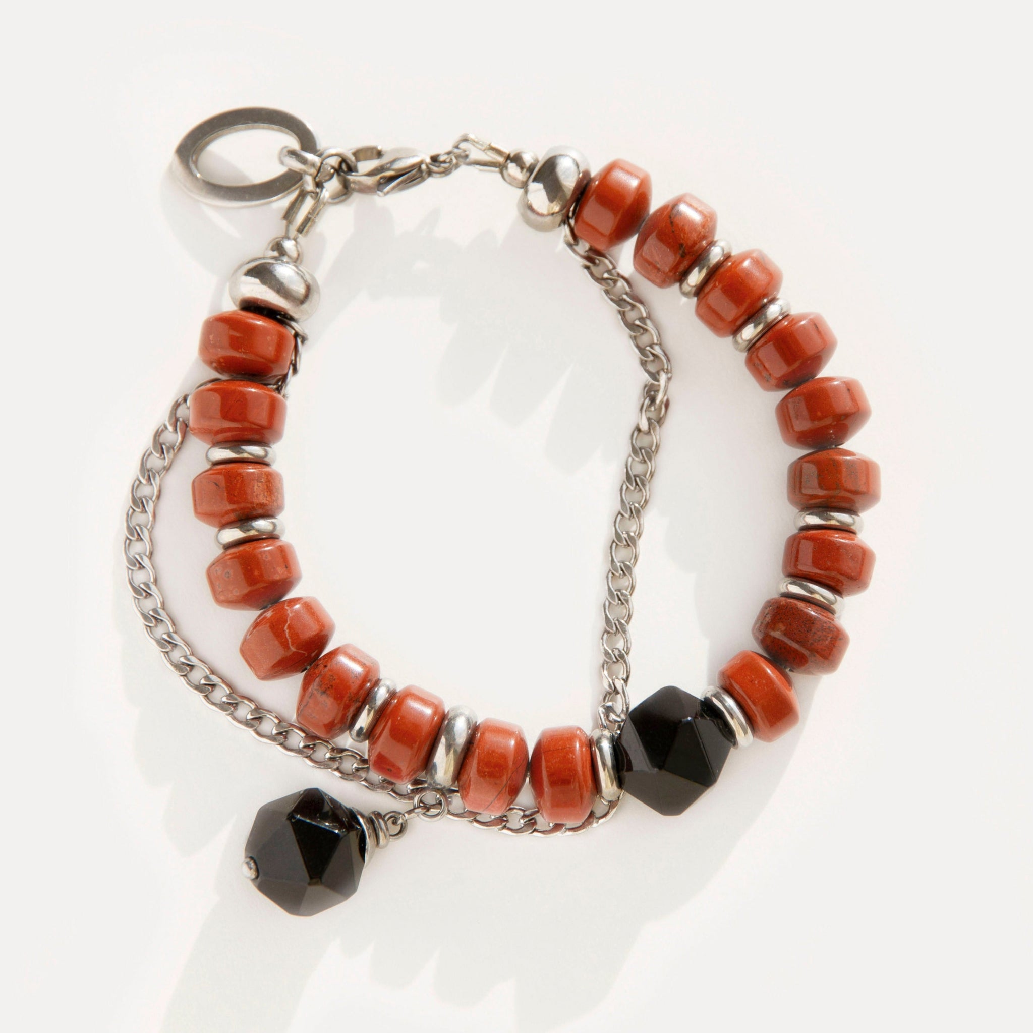 Red Outline Bracelet with terracotta jasper beads, faceted black agate, and stainless steel chain, blending bold geometry with urban-inspired elegance.