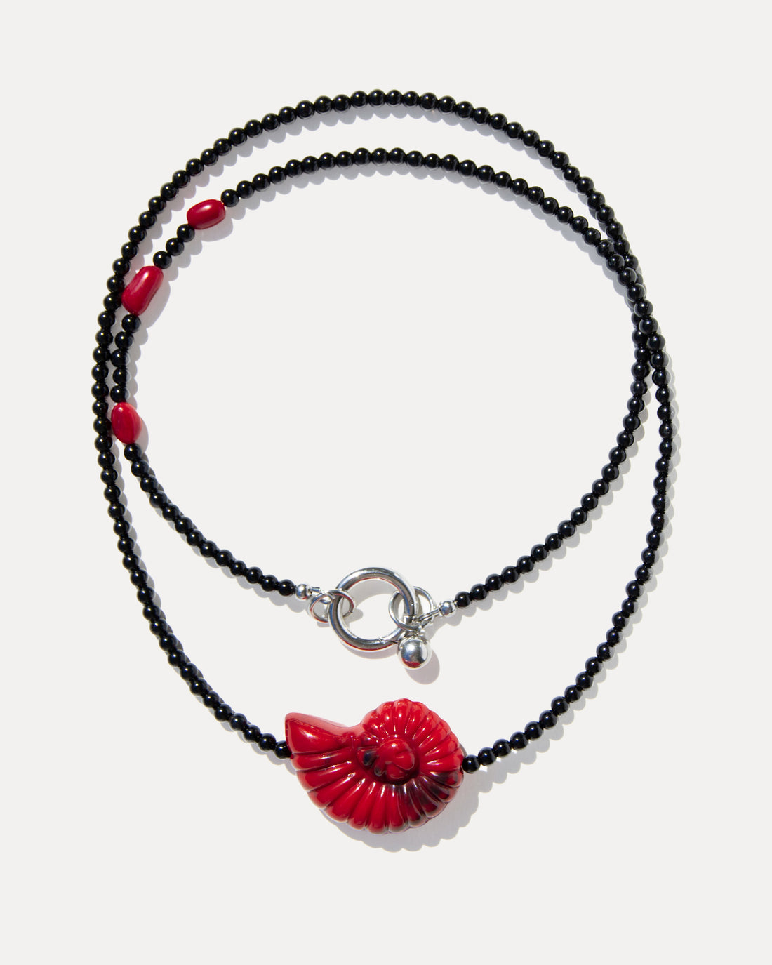 Layered black agate necklace with coral beads, a red shell bead and silver-tone clasp