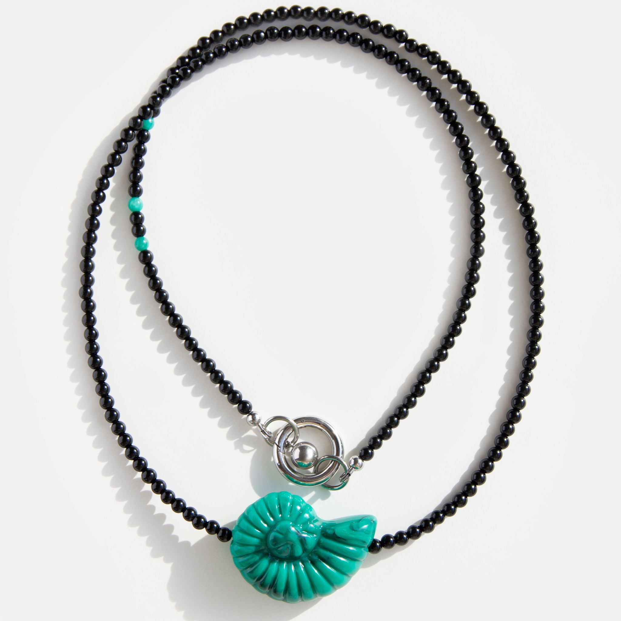 Emerald Shell Necklace with black agate beads, amazonite accents, and sculptural green shell pendant, handmade by Jewell Reef.
