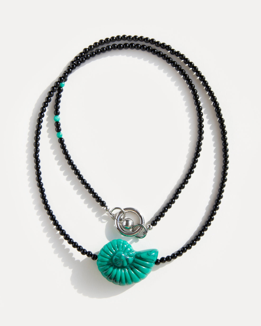 Emerald Shell Necklace with black agate beads, amazonite accents, and sculptural green shell pendant, handmade by Jewell Reef.