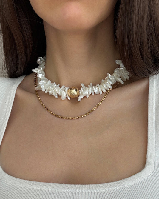 Fiesta Gold Necklace styled on model, layered shell bead choker with minimalist gold chain
