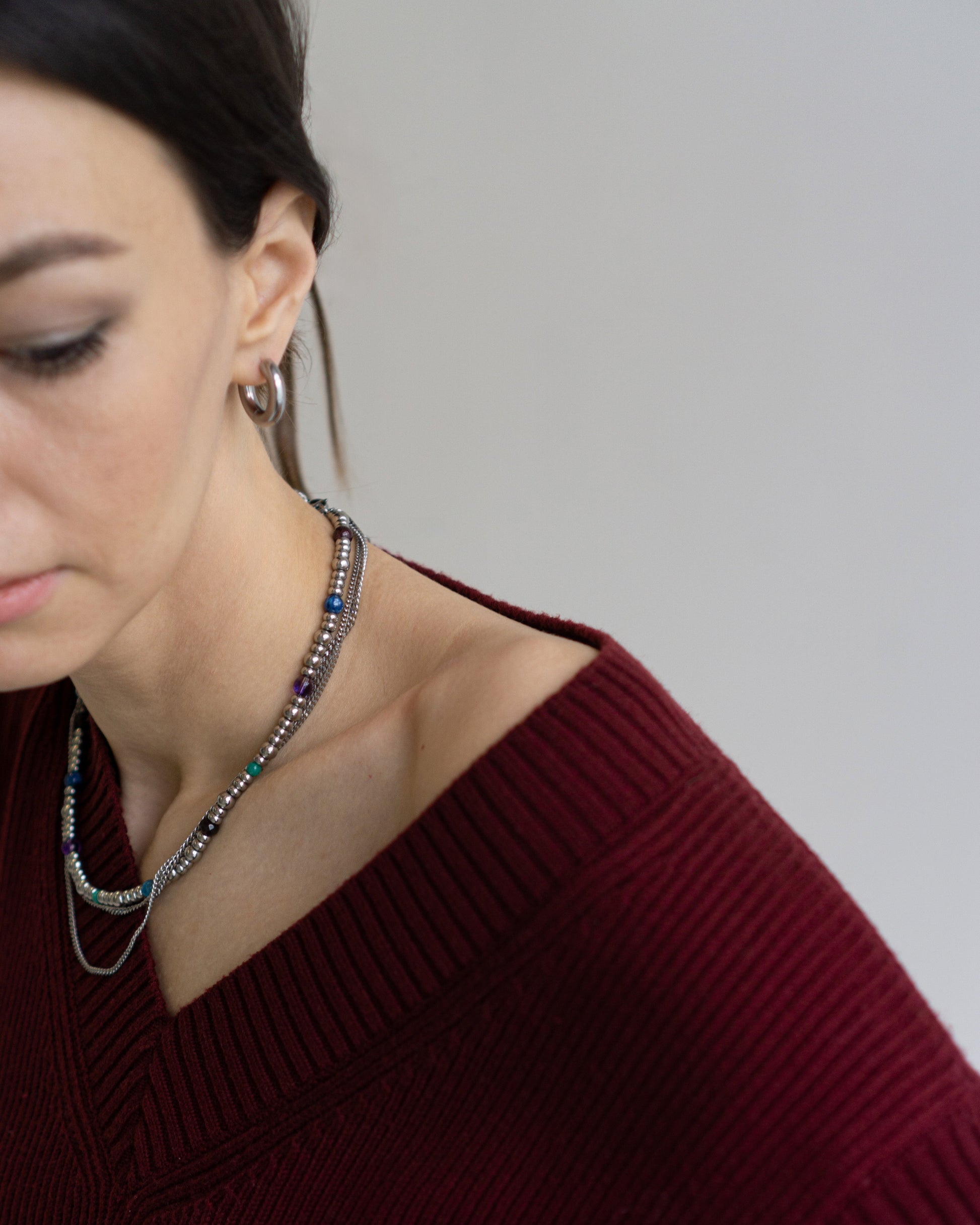 GEMS Necklace by Jewell Reef styled on model - multistrand necklace with colorful gemstones and stainless steel chains. A modern design for everyday elegance.
