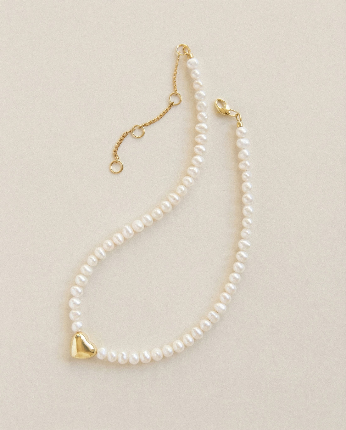 Freshwater pearl choker necklace with 18k gold plated heart charm, minimalist pearl necklace with extender chain on neutral background