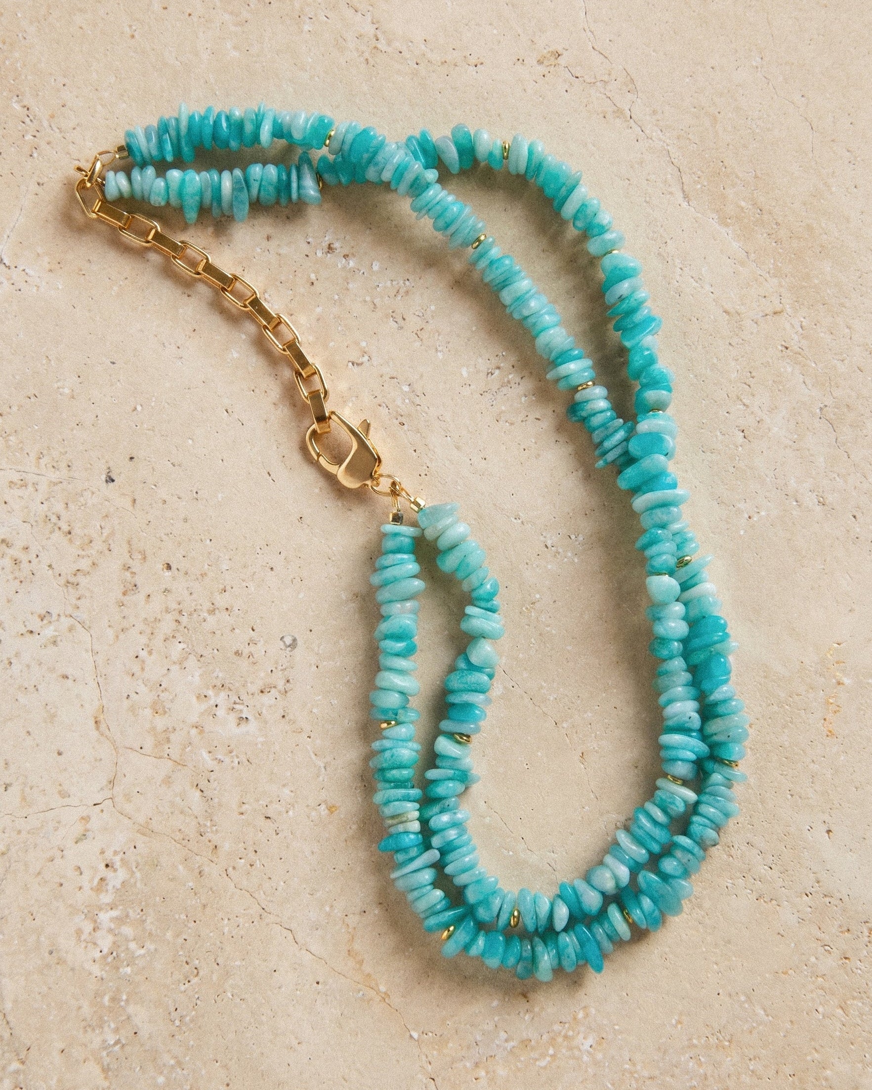 Layered amazonite necklace with irregular turquoise beads, small gold accents and adjustable gold-plated clasp on stone.
