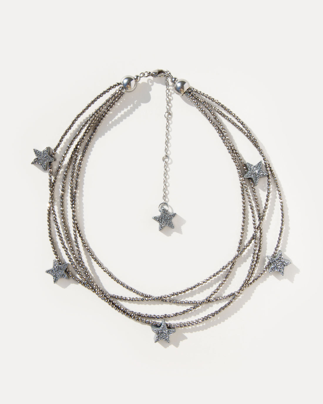 Make a Wish Necklace with five strands of shimmering hematite beads and druzy agate star charms. A layered statement necklace for modern styling.