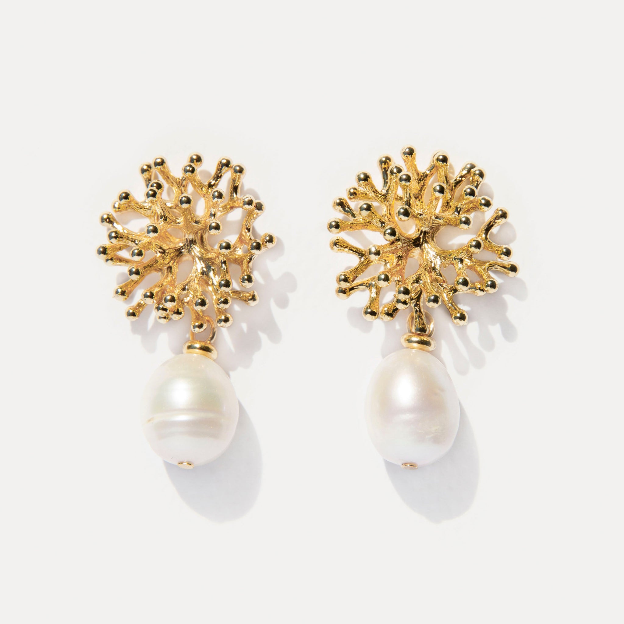 Mermaid’s Secret Earrings — 18K gold-plated coral shaped studs with natural freshwater pearls, capturing organic elegance and soft ocean light.