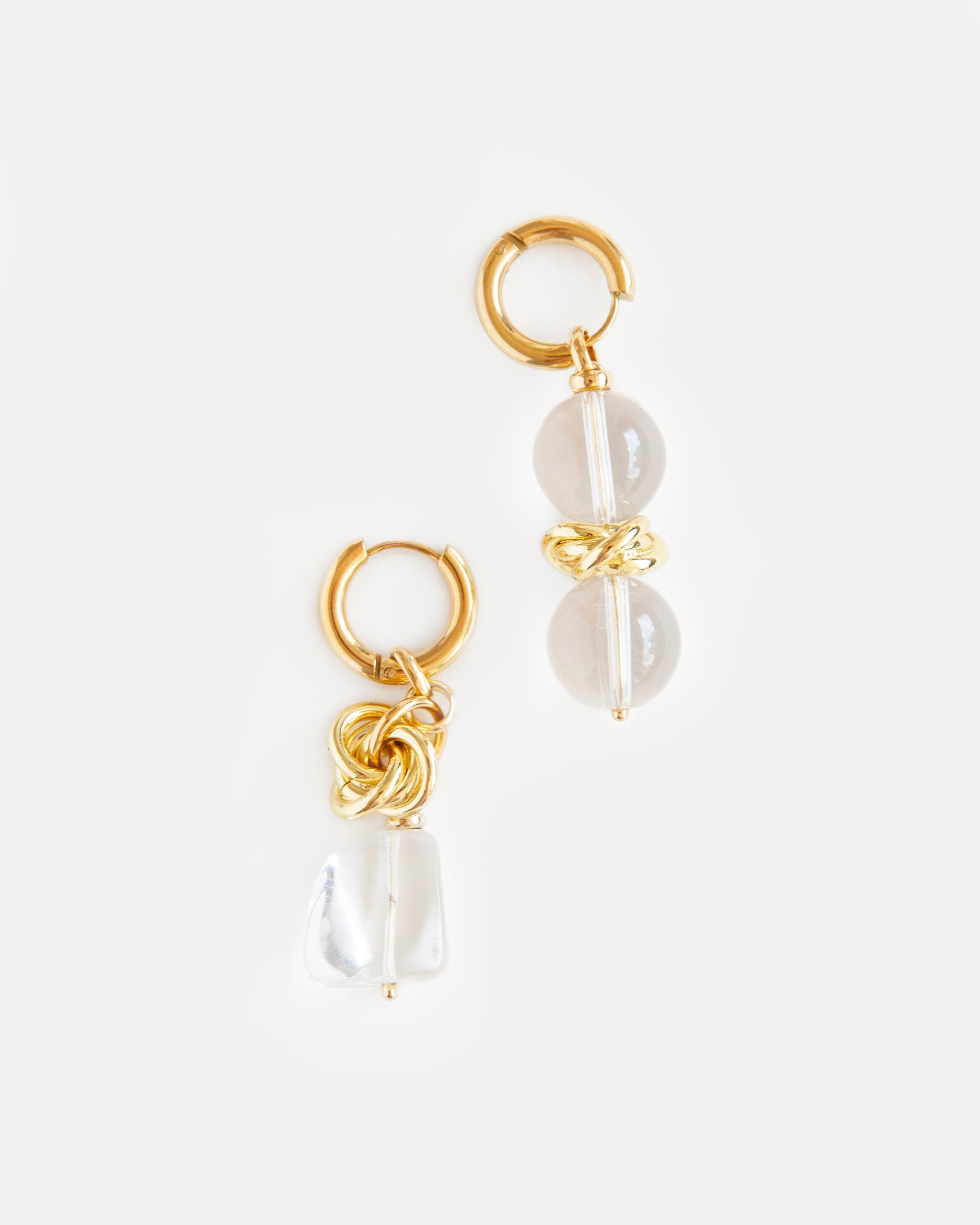 Asymmetric Nora Earrings with clear quartz and gold-plated brass, bold mismatched statement jewelry reflecting modern sculptural design and elegance.