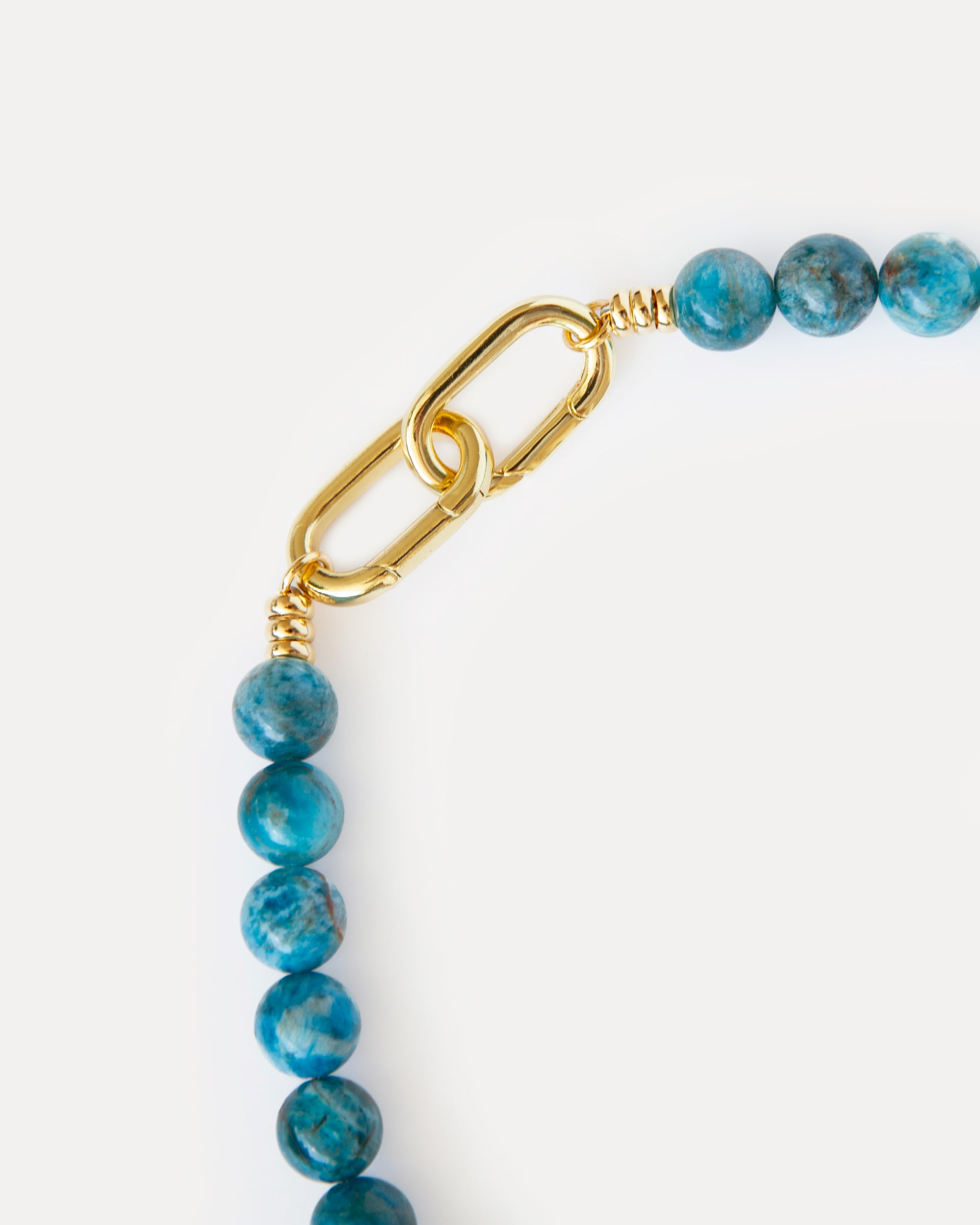 Close-up of Ocean View Necklace clasp with gold-plated hardware and vivid blue apatite beads, showing refined craftsmanship and contemporary statement design.