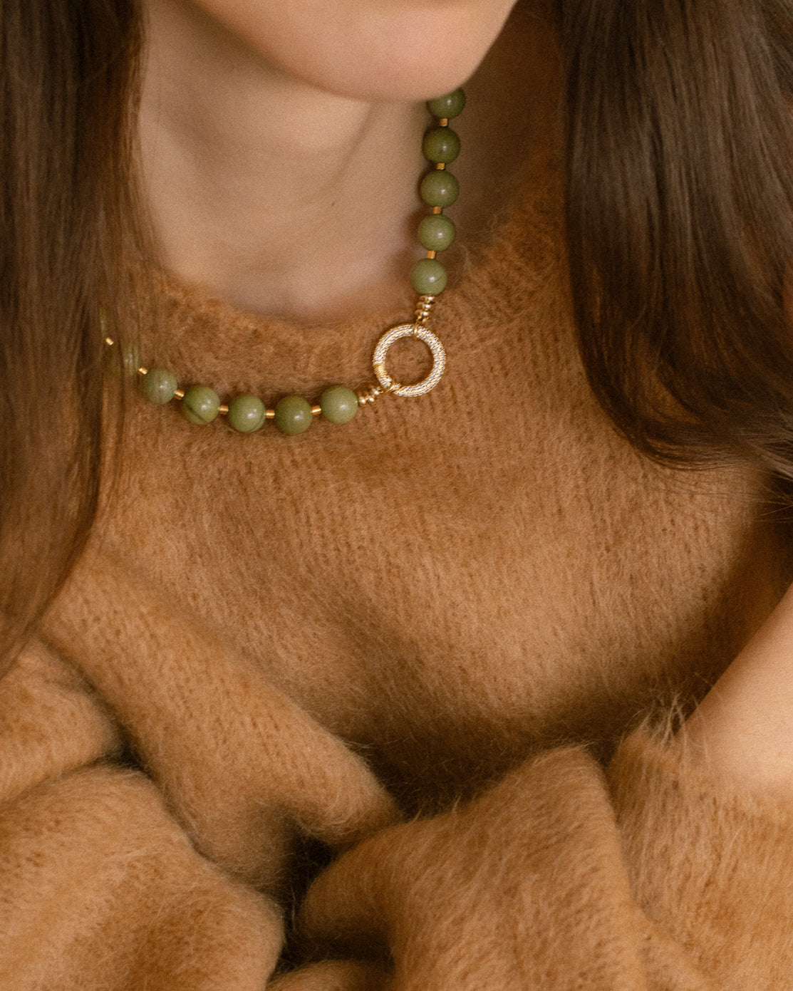Close-up of Olivia Necklace with polished olive-green agate beads and bold cubic zirconia gold-plated clasp, a modern statement jewelry piece.