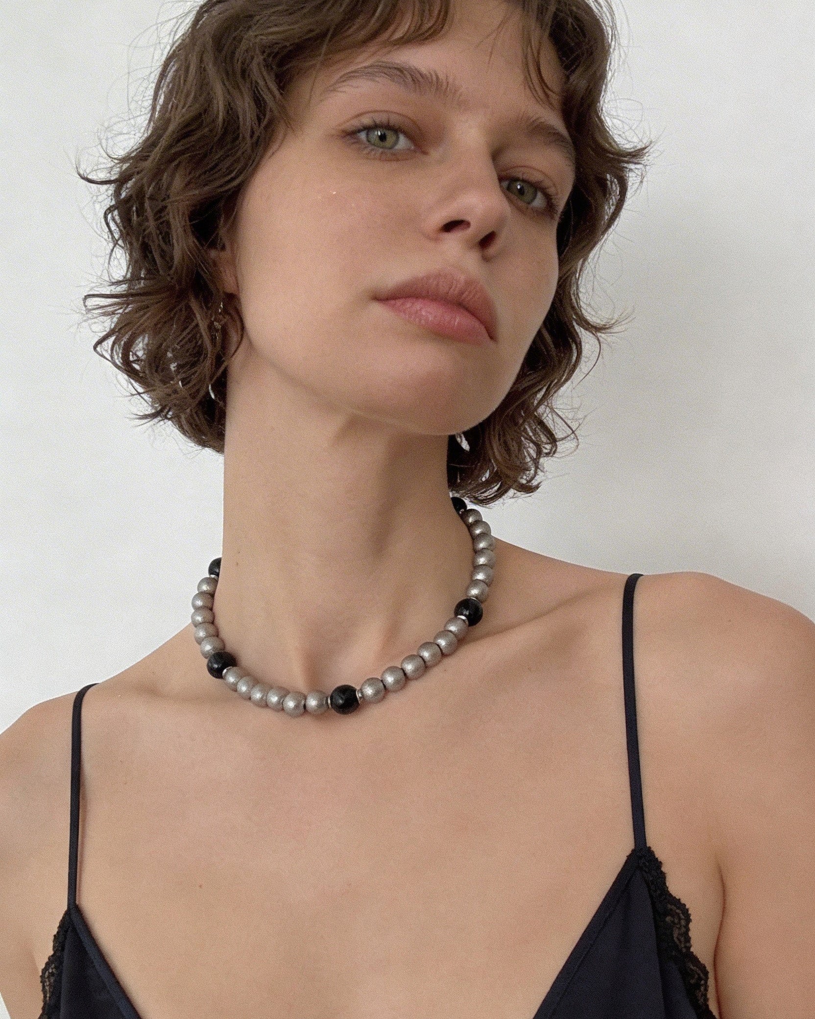 Black agate beaded choker necklace with matte silver beads worn on neck, minimalist natural stone jewelry
