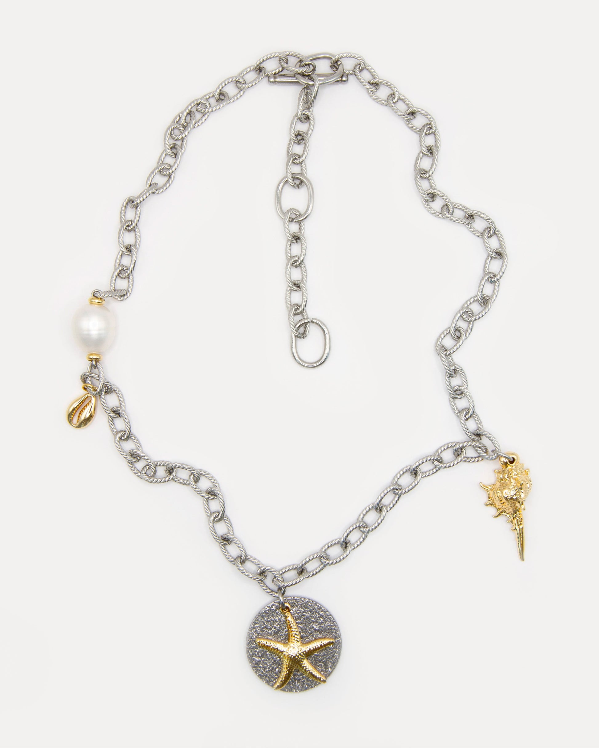 Sea Gifts Necklace with bold silver chain, freshwater pearl, golden shell, starfish and snail charms - a playful mixed metal jewelry piece with coastal charm.