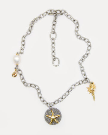 Sea Gifts Necklace with bold silver chain, freshwater pearl, golden shell, starfish and snail charms - a playful mixed metal jewelry piece with coastal charm.
