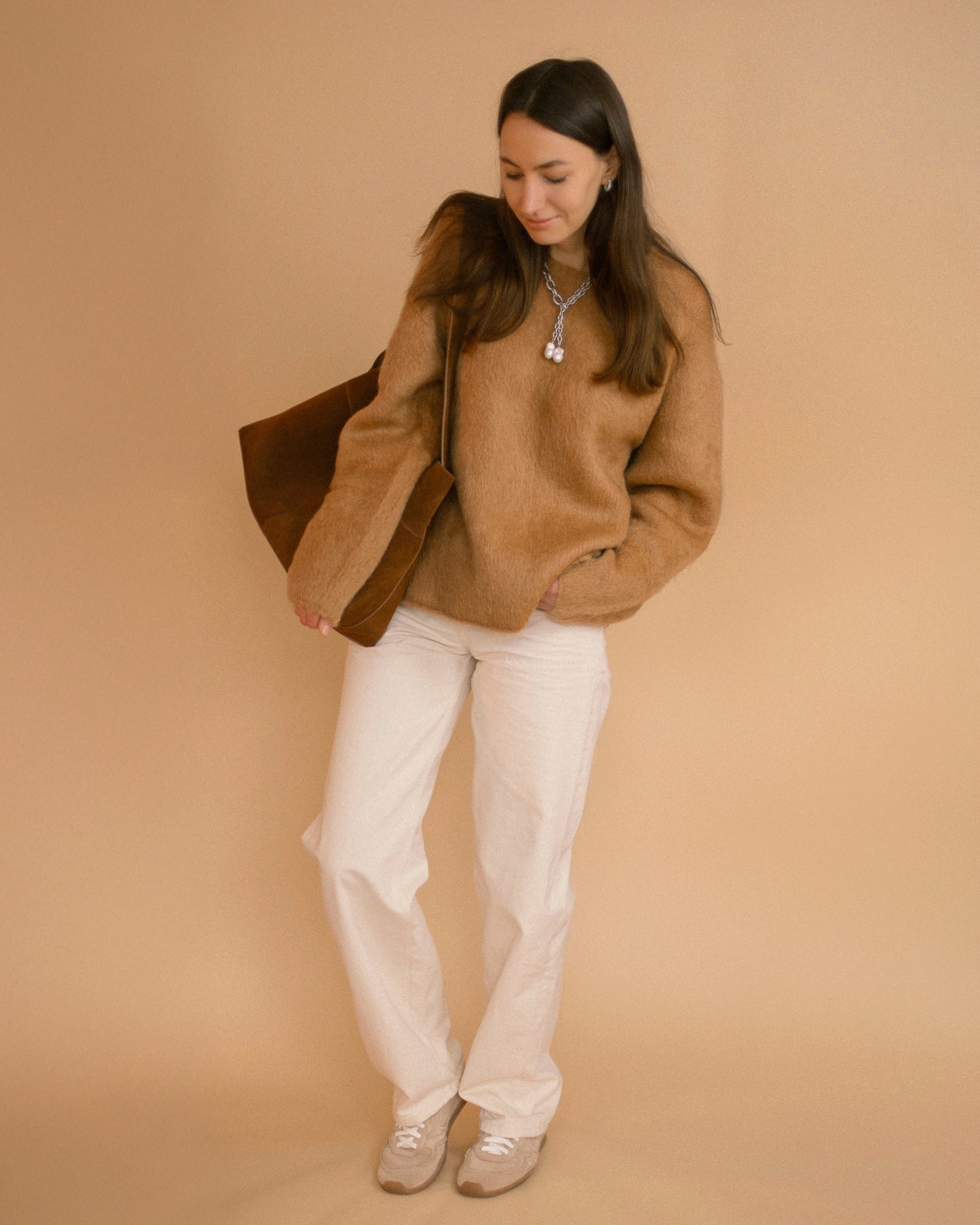 Casual outfit with oversized beige sweater and Silver Rain Necklace, blending bold pearls and steel for refined everyday styling.
