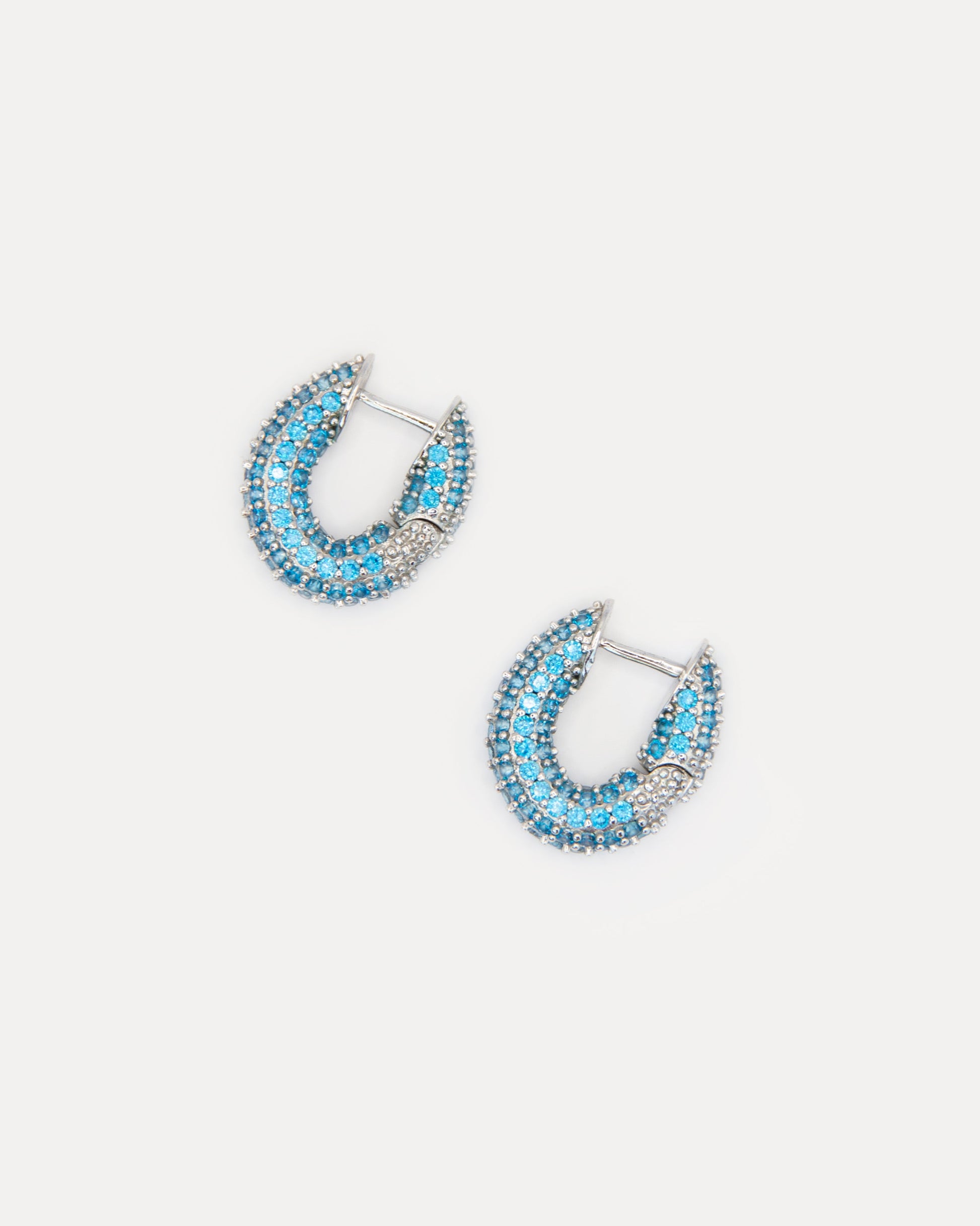 Blue cubic zirconia hoop earrings in silver-tone brass. Elegant, minimalist sparkle earrings that brighten any look, day or night.