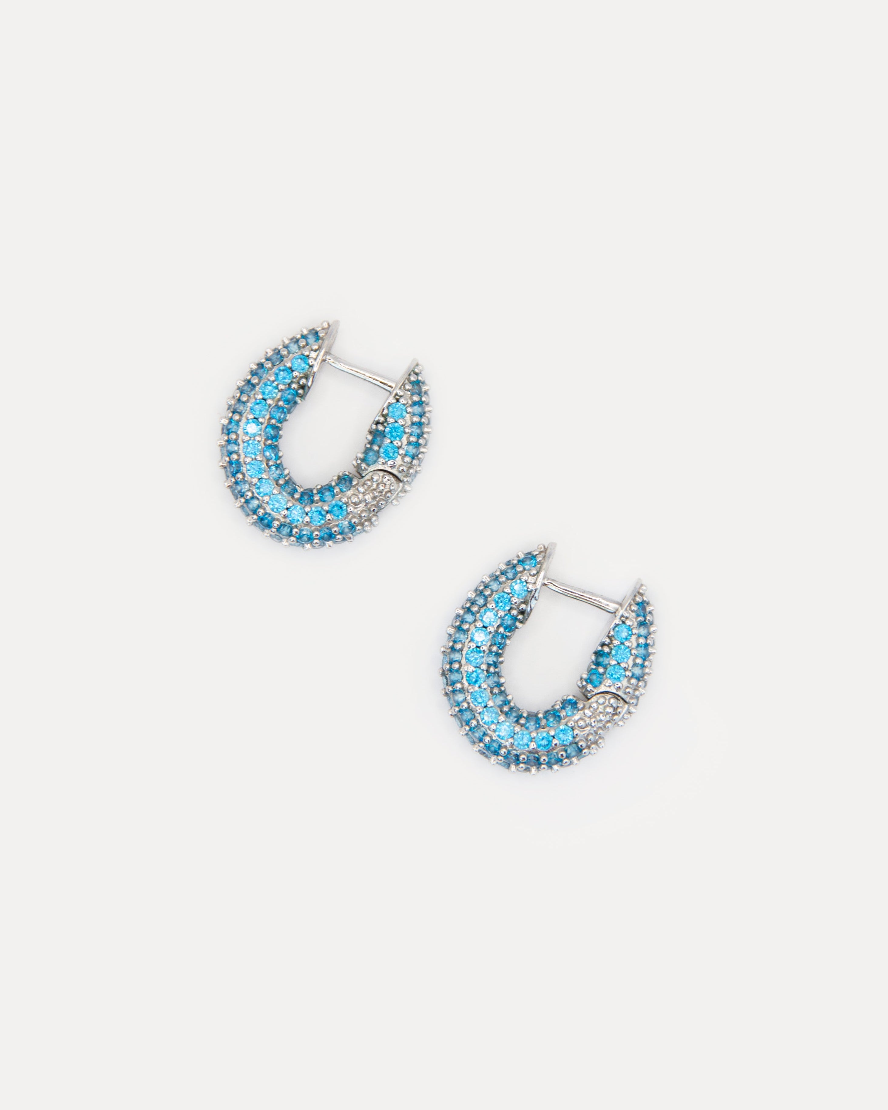 Blue cubic zirconia hoop earrings in silver-tone brass. Elegant, minimalist sparkle earrings that brighten any look, day or night.