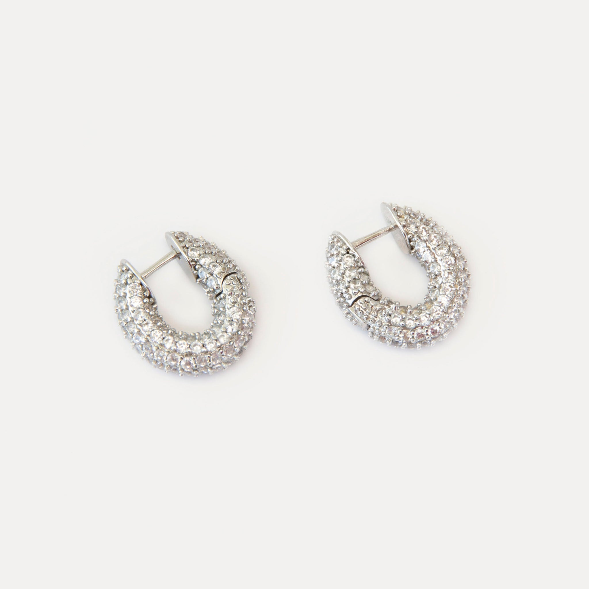 Mini hoop earrings with clear cubic zirconia on silver-tone brass. Crystal Sparkles earrings add refined shine and modern elegance to any look.