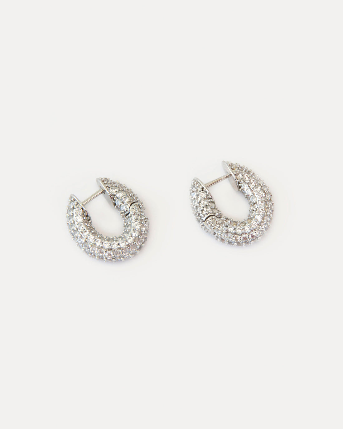 Mini hoop earrings with clear cubic zirconia on silver-tone brass. Crystal Sparkles earrings add refined shine and modern elegance to any look.