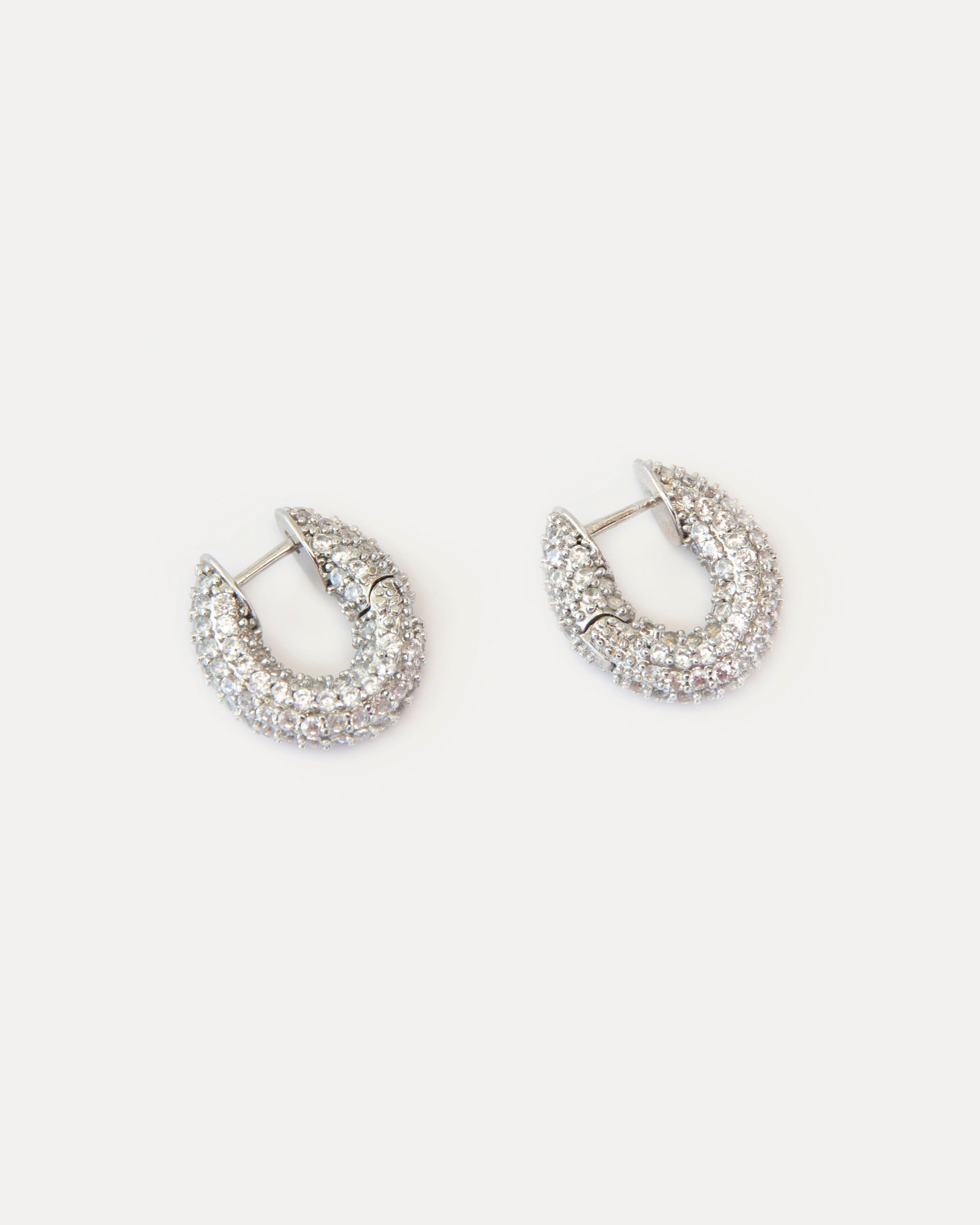 Mini hoop earrings with clear cubic zirconia on silver-tone brass. Crystal Sparkles earrings add refined shine and modern elegance to any look.