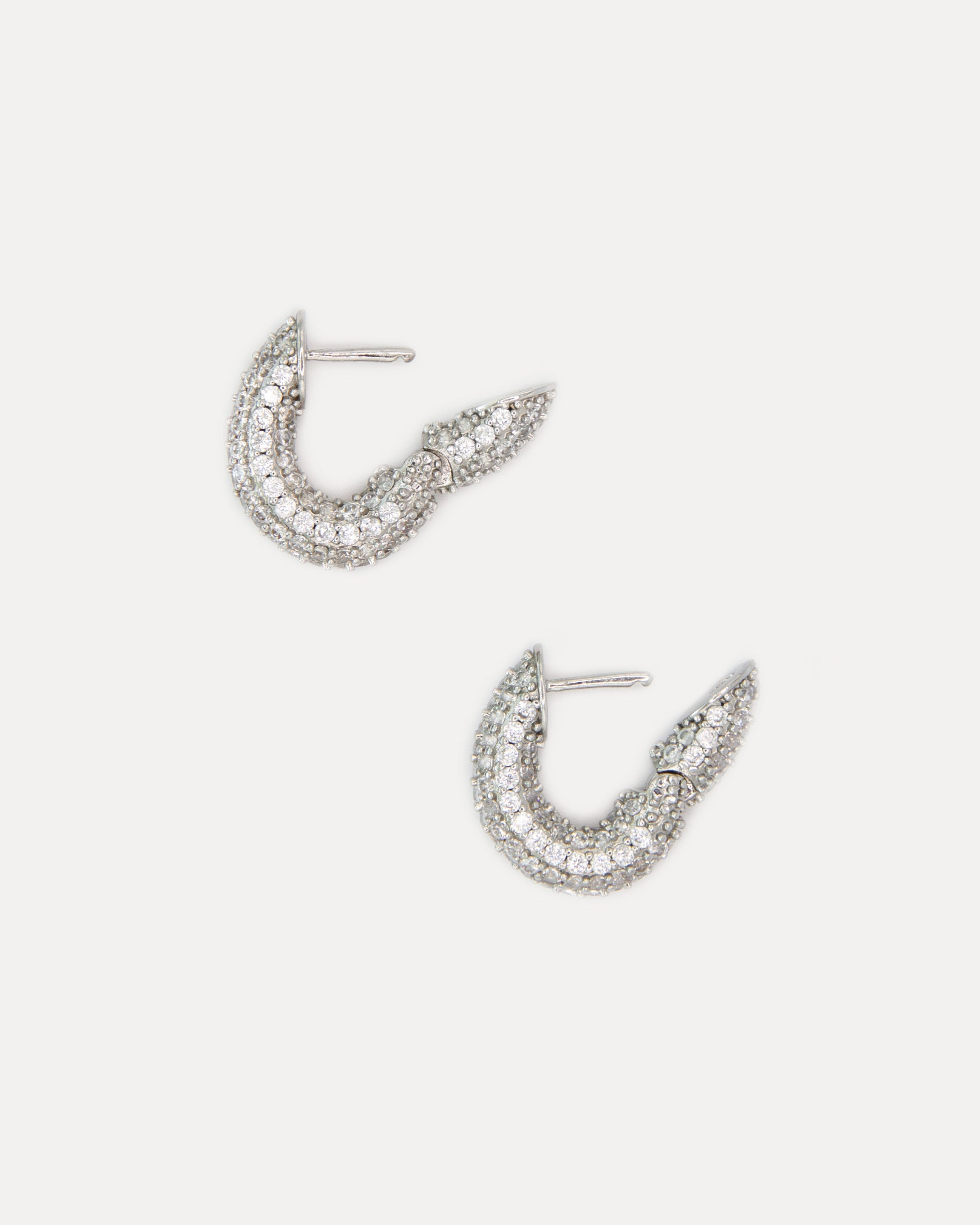 Close-up of Sparkles Earrings Crystal — silver-tone mini hoops with clear cubic zirconia stones that shimmer beautifully for an elegant modern look.
