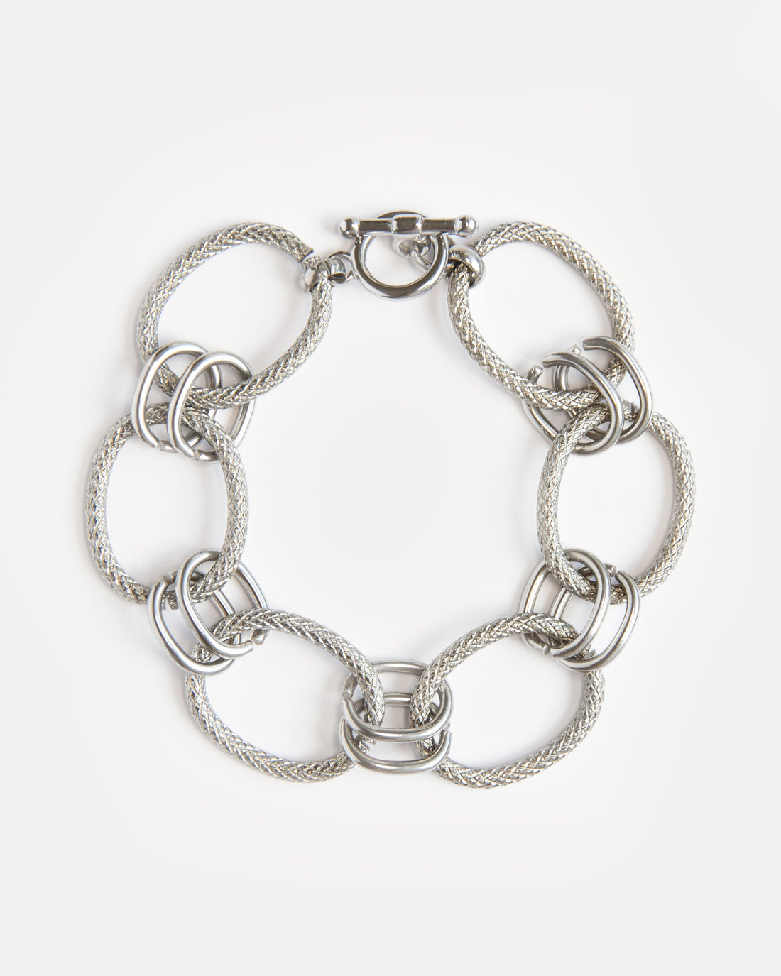 Bold stainless steel bracelet with textured woven links and modern clasp. A sculptural, timeless piece for everyday or statement styling.