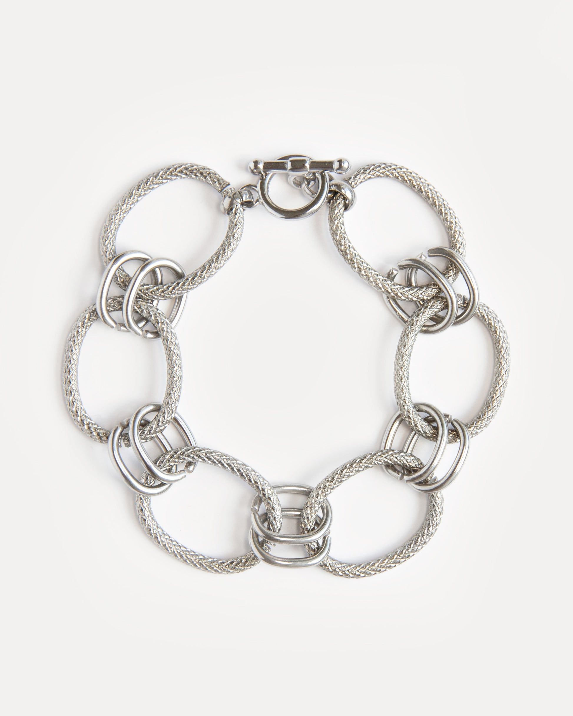 Bold stainless steel bracelet with textured woven links and modern clasp. A sculptural, timeless piece for everyday or statement styling.