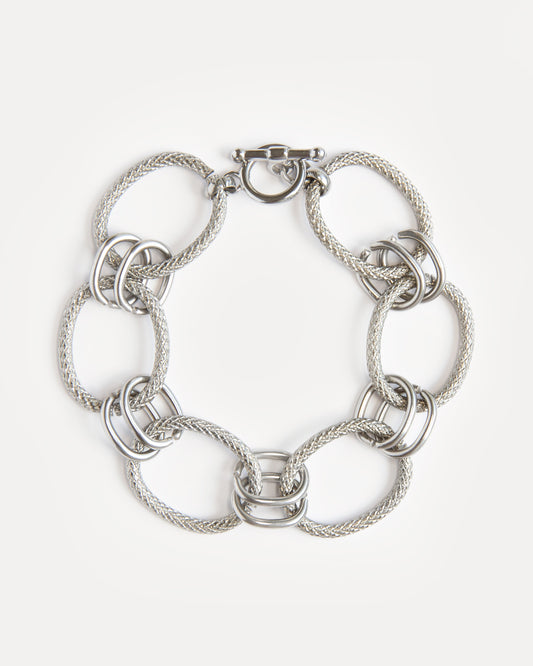 Bold stainless steel bracelet with textured woven links and modern clasp. A sculptural, timeless piece for everyday or statement styling.