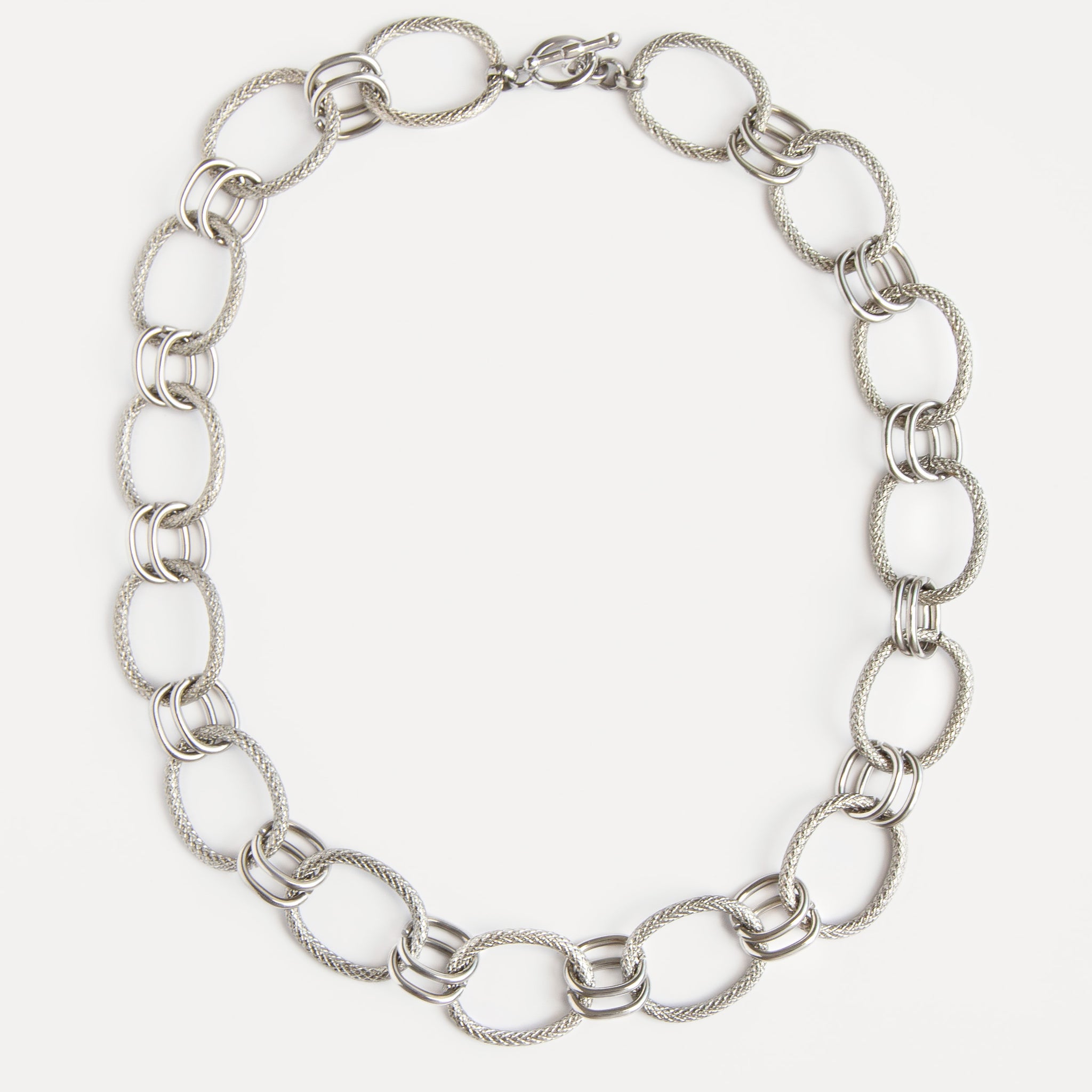 The Venus Necklace in polished stainless steel with sculptural twisted links — a timeless statement chain that feels modern and refined.