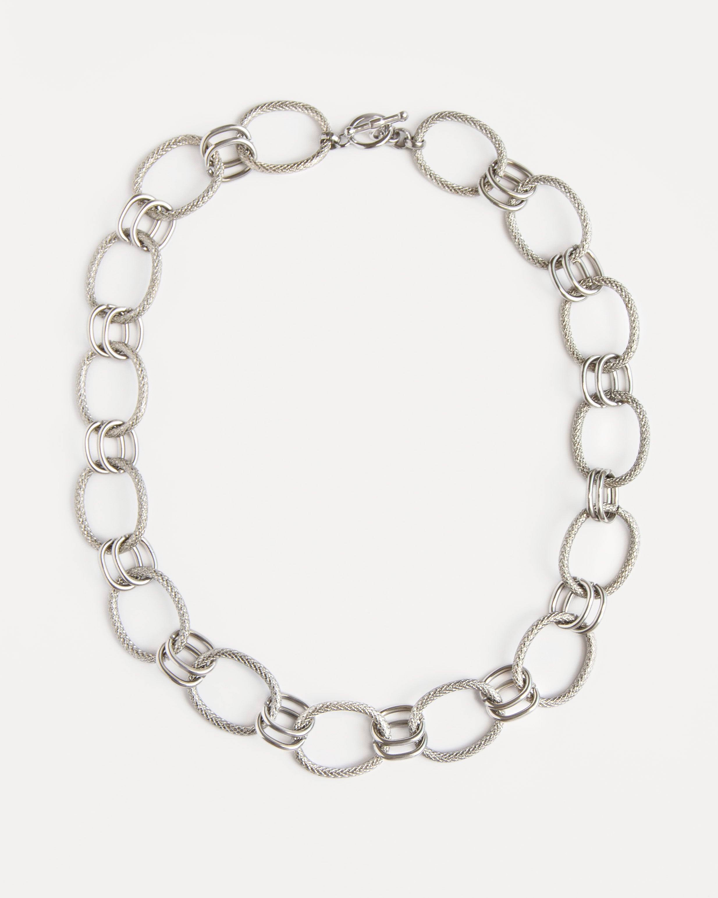 The Venus Necklace in polished stainless steel with sculptural twisted links — a timeless statement chain that feels modern and refined.
