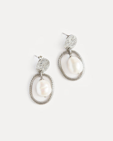 Sculptural pearl statement earrings with textured stainless steel oval frame — bold yet timeless design with modern elegance.